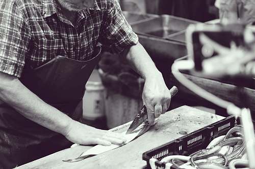 tsukiji market grayscale photography of man using knife japan